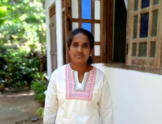 Yasawathie in front of her house