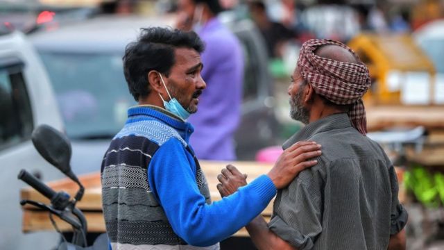 Labourers in conversation in Old Delhi India amid Covid-19 Coronavirus Pandemic on 11 March 2021.