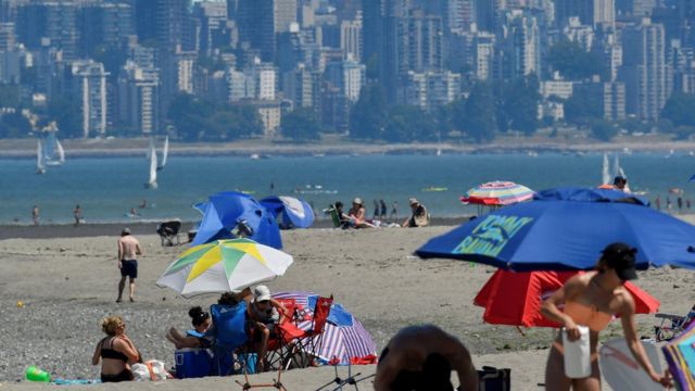 People head to the beach to cool off during the scorching weather of a heatwave in Vancouver,