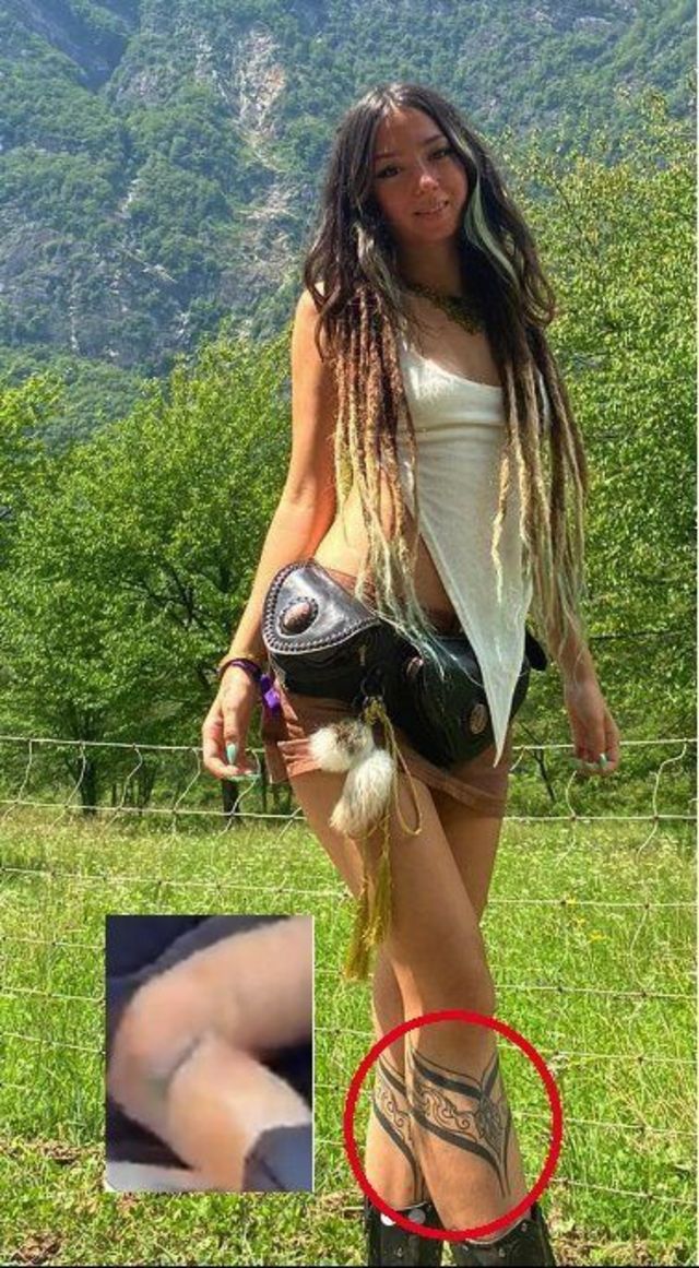 Shani Louk wearing shorts standing in a field with her distinctive tattoos on her legs visible