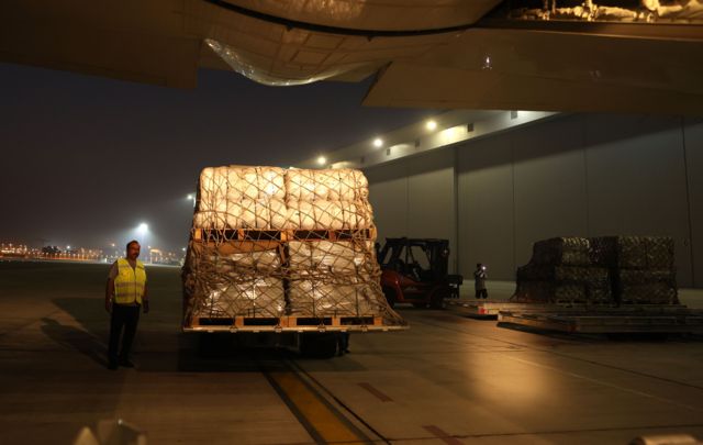 Workers load an airplane heading to Egypt with humanitarian aid and relief goods to the Gaza Strip, at Dubai International Airport, United Arab Emirates, 19 October 2023. The International Humanitarian City (IHC) based in Dubai is sending humanitarian aid and relief goods to Gaza. The Israeli government said on 18 October it will not prevent humanitarian aid entering Gaza from Egypt