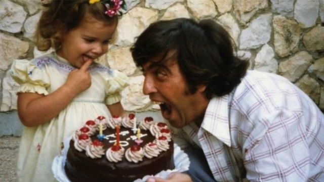  Rami with his daughter laughing while looking at her birthday cake