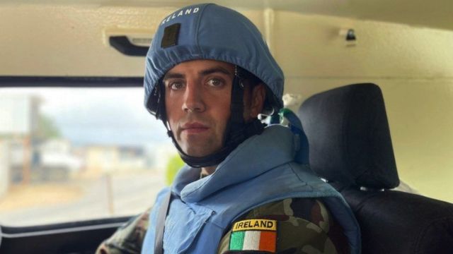 Peacekeeper Captain Tony Smith looks at the camera while sat in an armoured vehicle